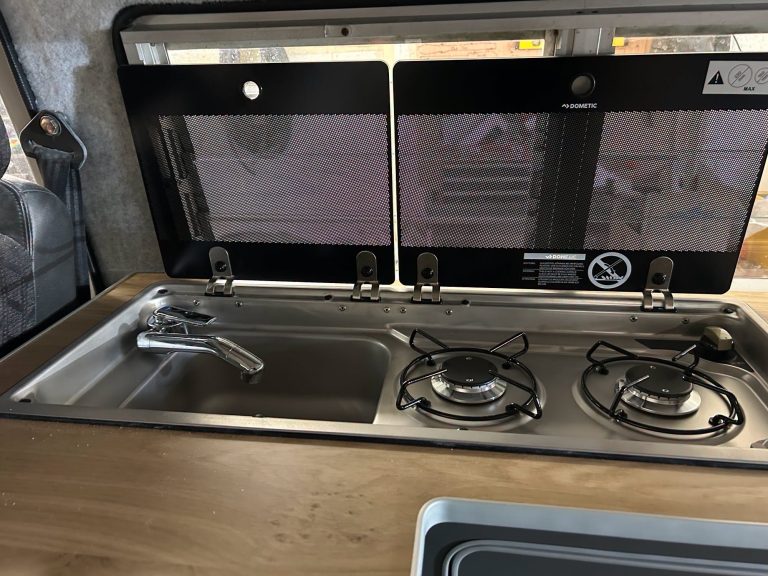 a chrome campervan gas hob. 2 gas rings with a sink installed in a campervan by the dub hut in ashford kent